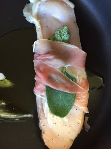 Tuck a sage leaf into each prosciutto wrapped chicken piece.